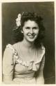 Smiling woman with elaborate hairpiece