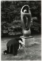 Priest photographing Henry Moore sculpture, Rotterdam, Holland