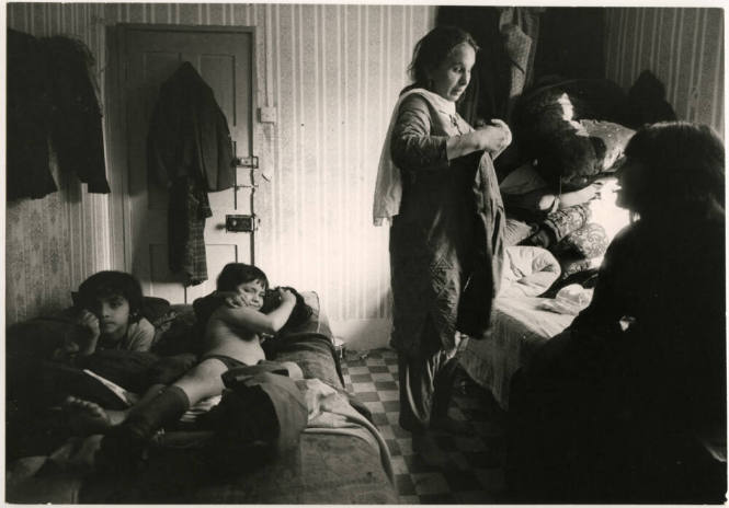 A family of eight puts mattresses on the floor at night and stacks them up by day, London England