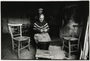 Elderly woman knitting at home, Sicily, Italy