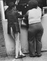 Skinny man and fat woman seen from behind