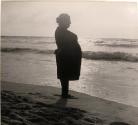 Silhouette of large woman on beach