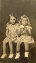 Two girls seated on table