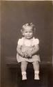 Little girl seated on table